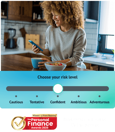 A woman standing in her kitchen looking down at her phone and smiling. Below shows Wealthify's 5 risk levels and an award for Best Personal Finance Online Provider 3 years running at the Personal Finance Awards 2025