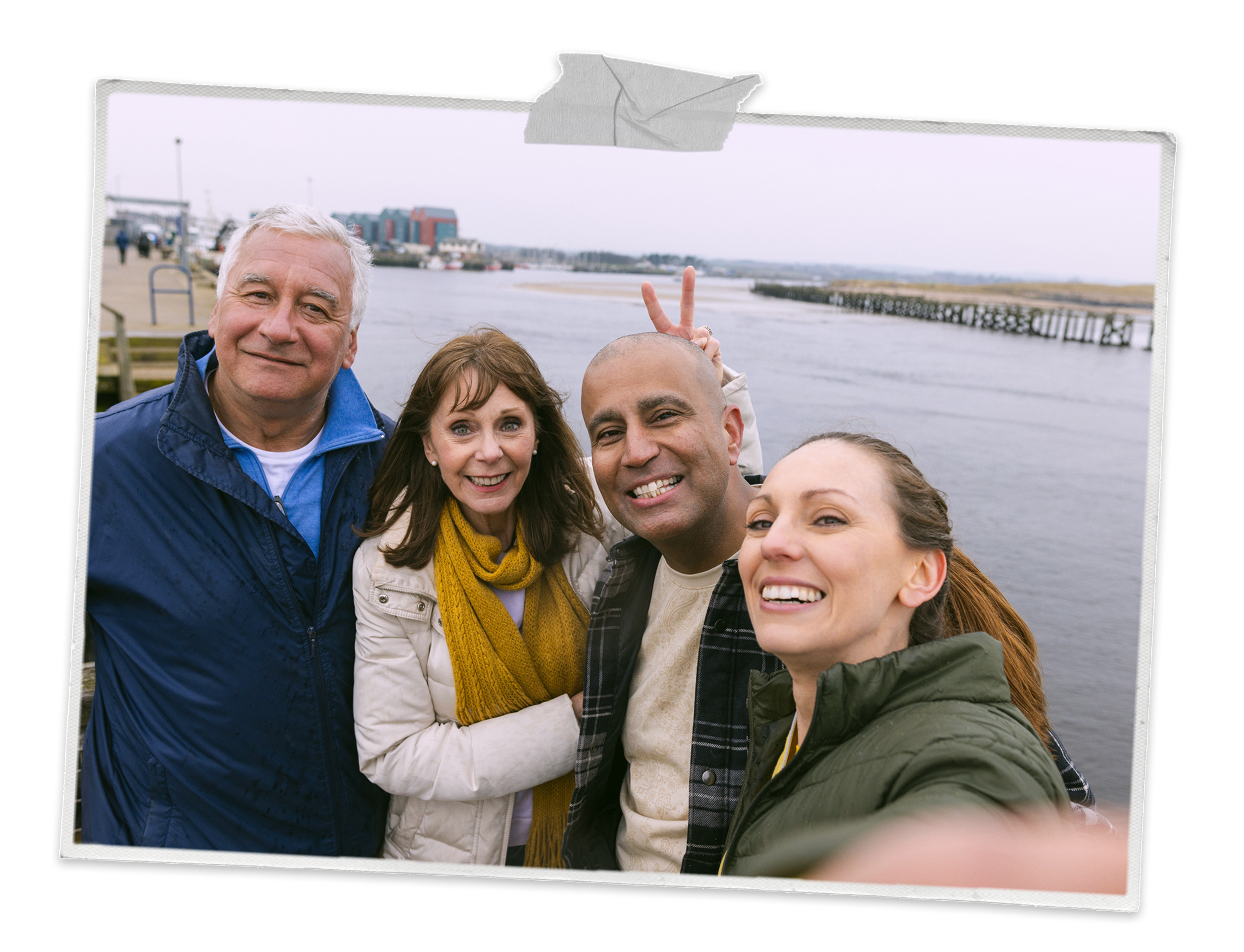 Two couples taking a selfie on a pier