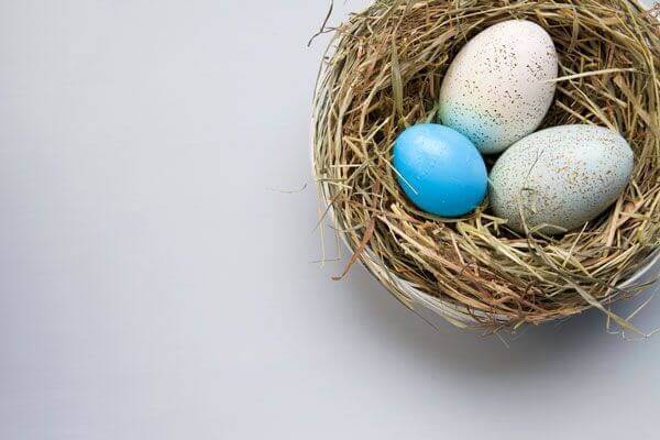 An overhead view of 3 eggs in a basket