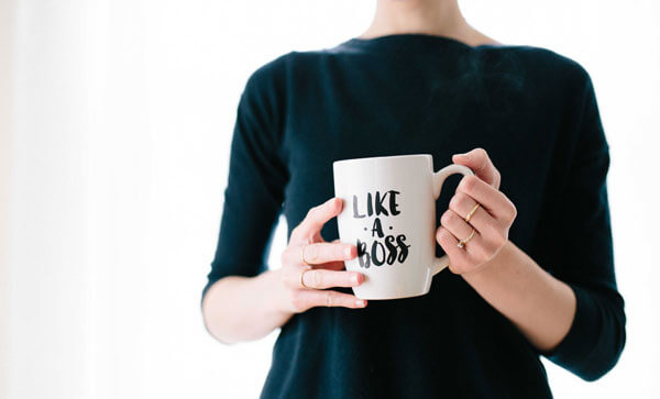 Woman with Like a Boss mug