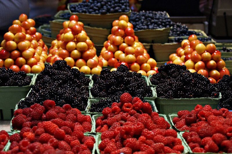 Piles of colourful fruit at a greengrocer's stand