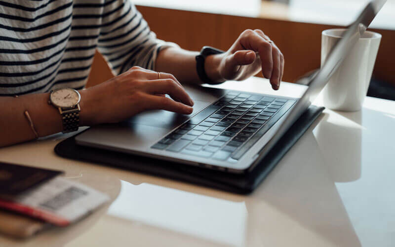 Woman using her phone and laptop