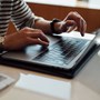 Woman using her phone and laptop 