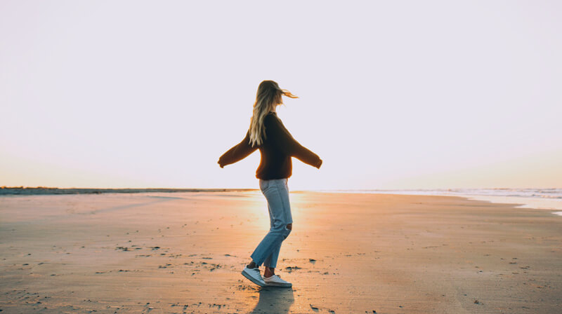 Woman on the beach | Wealthify