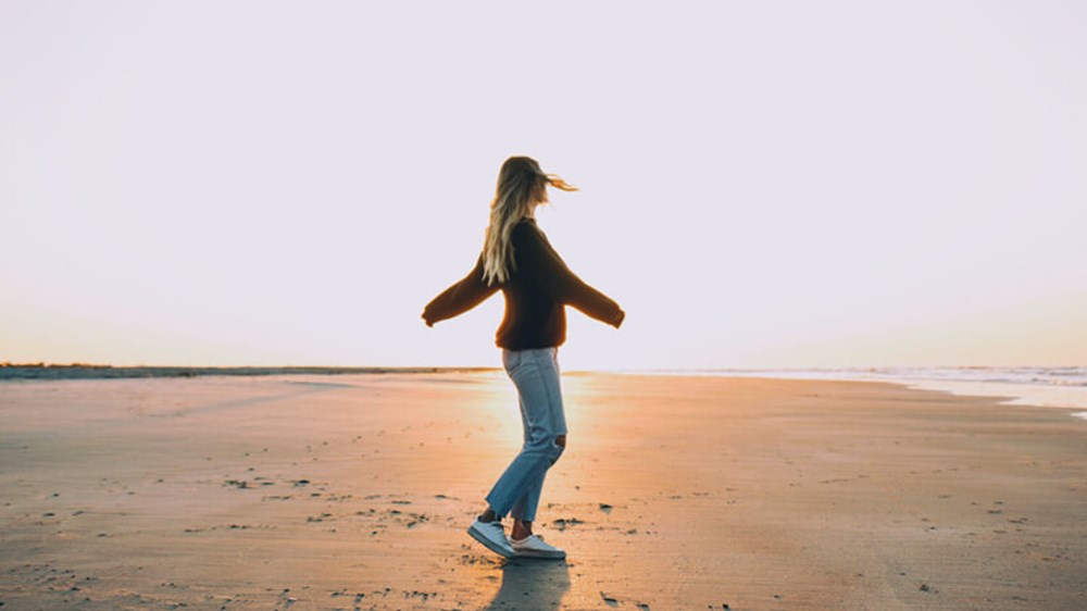 Woman on the beach | Wealthify