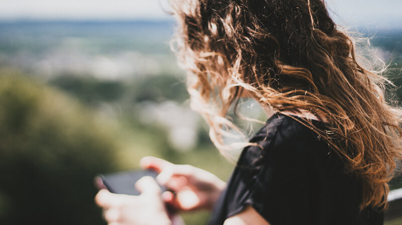 Woman looking at phone | Wealthify