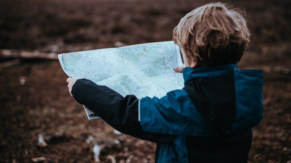 Child reading map | Wealthify