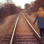 Woman walking on railway tracks | Wealthify 