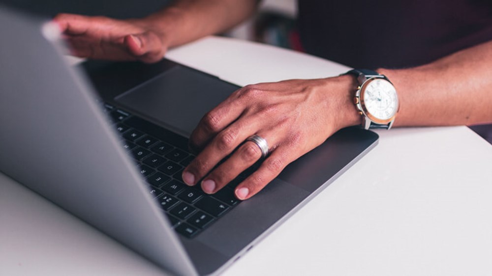 Person typing on laptop | Wealthify