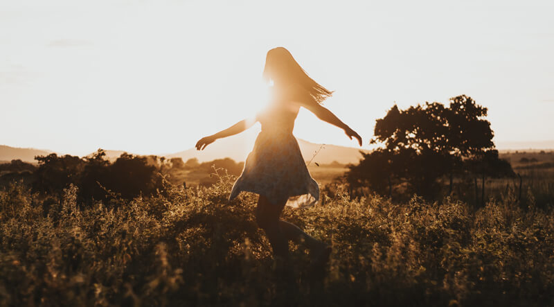 Woman walking in field | Wealthify