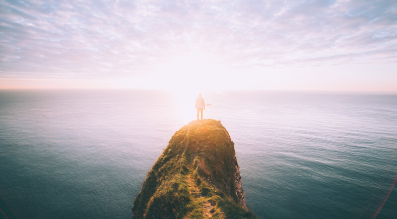 Man looking at the horizon by the sea | Wealthify
