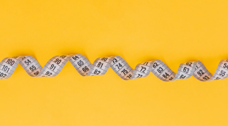 a measuring tape laid out in a spiral.