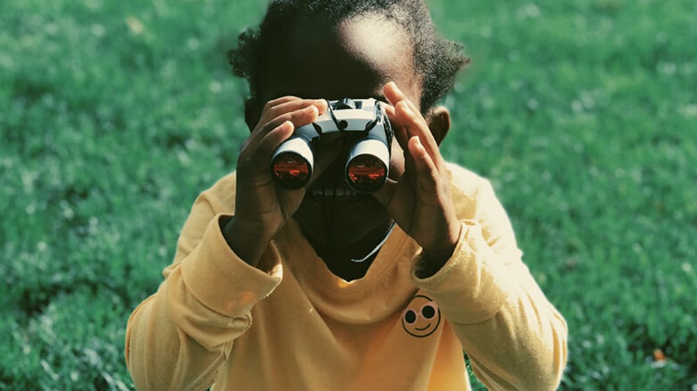 Child using binoculars | Wealthify
