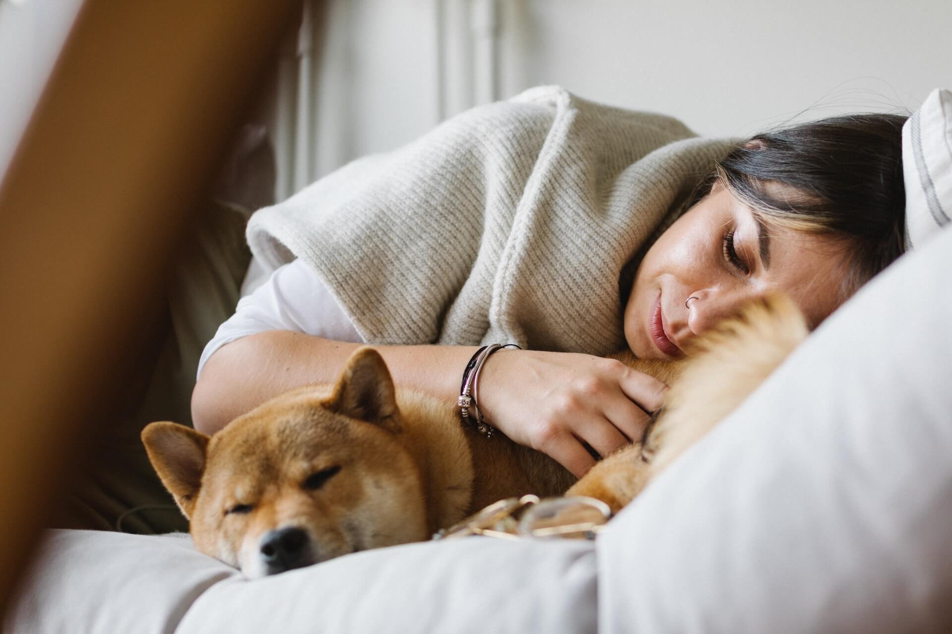 Woman sleeping with dog