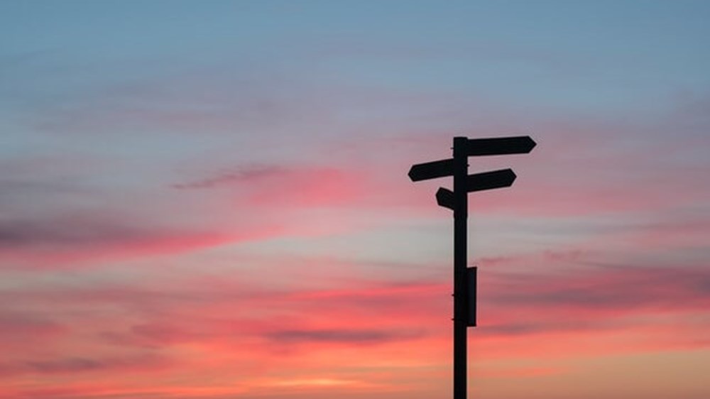sign post against sunset | wealthify.com