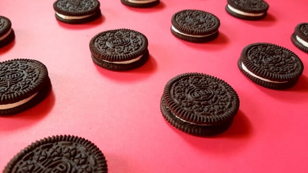 a dozen oreo cookies on a pink background | wealthify.com