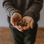 Child holding out coins in hand
