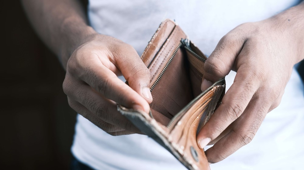 Close up of hands holding open an empty wallet