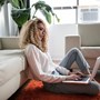 woman sitting with a laptop on the floor | wealthify.com