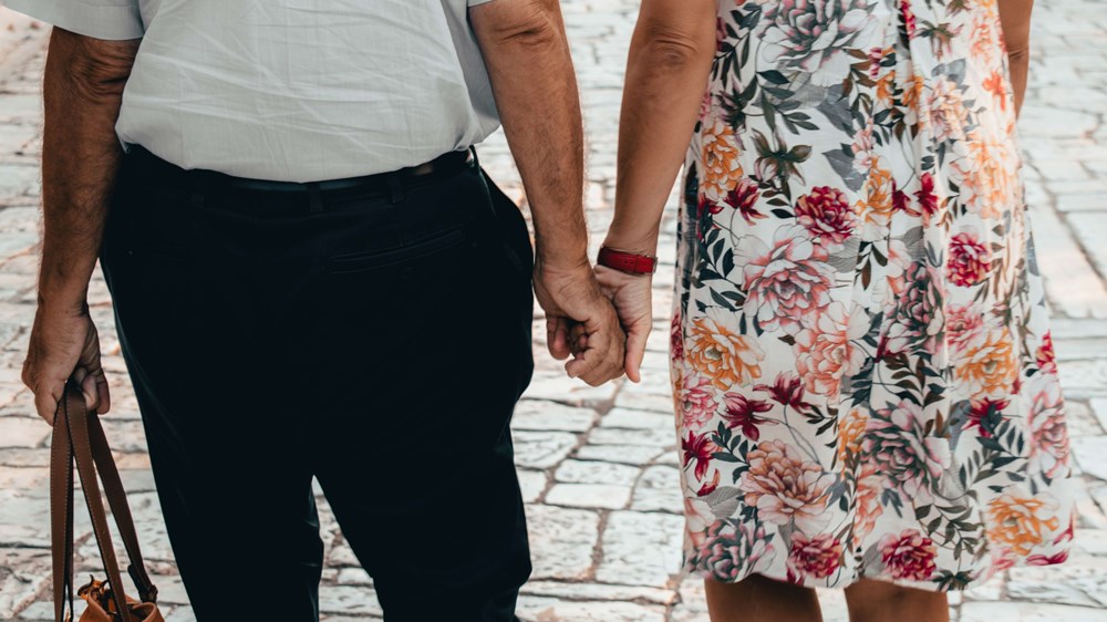 Close up of older couple holding hands