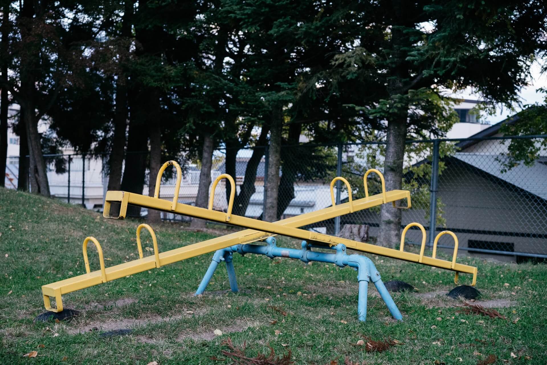 Two yellow seesaws one facing up the other down | Wealthify.com