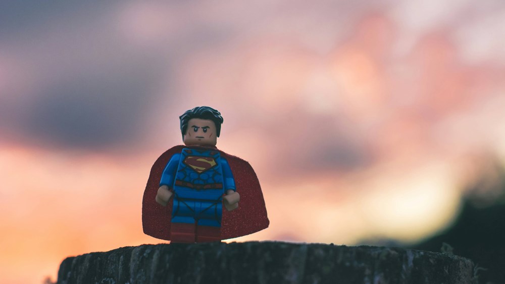 Superhero lego figure standing on rock