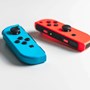 Photograph of a blue and red remote controller for a video game