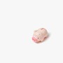 A little pink piggy bank on an off white background