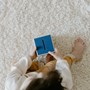 Birds eye view of a child holding a moneybox.