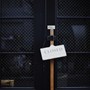 A photograph of two doors with a shop sign that reads Closed on the door handle.
