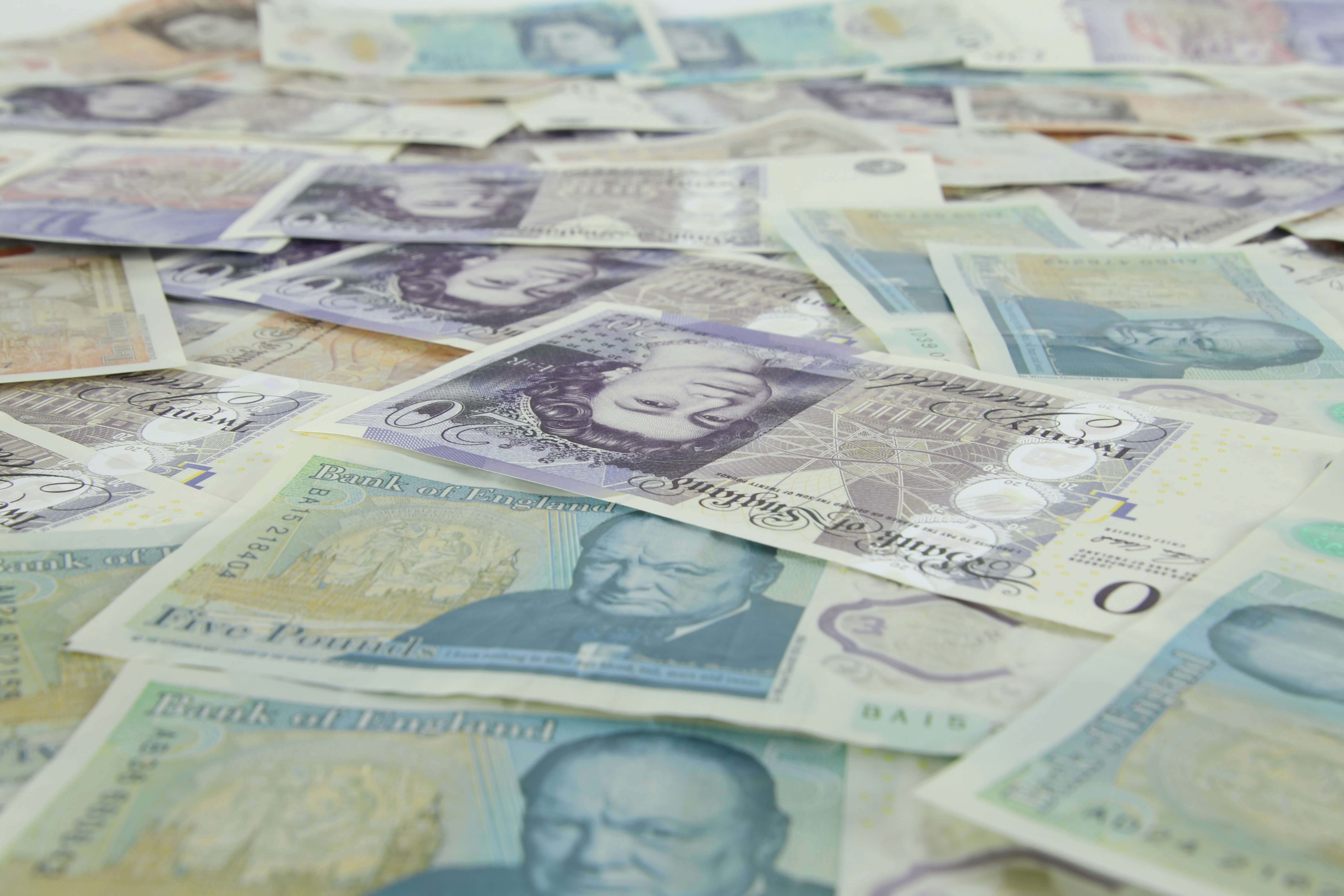 British bank notes laid out on a flat surface | Wealthify