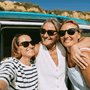3 women posing in front of a camper van 